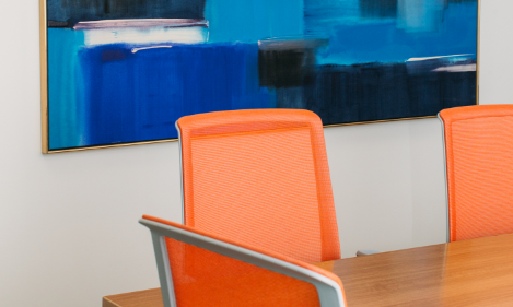 Orange office chairs around a table.